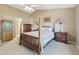 Bedroom featuring a four poster bed, neutral colored carpet, and traditional furnishings at 7450 Deville Ct, Indianapolis, IN 46256