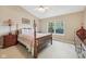 Well lit bedroom featuring a four poster bed, ceiling fan, and neutral colored carpet at 7450 Deville Ct, Indianapolis, IN 46256