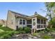 Charming home exterior with a cozy screened porch and landscaped backyard at 7450 Deville Ct, Indianapolis, IN 46256