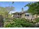 Beautiful backyard of home featuring a screened in porch and mature trees and foliage at 7450 Deville Ct, Indianapolis, IN 46256