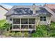 Rear exterior view featuring a screened in porch and an easy access staircase at 7450 Deville Ct, Indianapolis, IN 46256