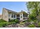 Charming home exterior with a cozy screened porch and landscaped backyard at 7450 Deville Ct, Indianapolis, IN 46256