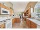 Traditional style kitchen with tiled floor, white appliances and wooden cabinets at 7450 Deville Ct, Indianapolis, IN 46256
