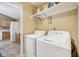 Convenient laundry room with appliances, shelving, and easy access to the kitchen at 7450 Deville Ct, Indianapolis, IN 46256
