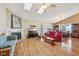 Spacious living room with a vaulted ceiling, fireplace, hardwood floors, and access to the dining area at 7450 Deville Ct, Indianapolis, IN 46256