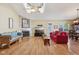 Bright living room featuring skylights, hardwood floors, a fireplace, and comfortable seating area at 7450 Deville Ct, Indianapolis, IN 46256
