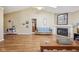 Bright living room featuring a fireplace, hardwood floors, neutral paint, and a vaulted ceiling with skylights at 7450 Deville Ct, Indianapolis, IN 46256