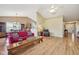 Open-concept living room with hardwood floors, neutral paint, and a view into the dining and kitchen areas at 7450 Deville Ct, Indianapolis, IN 46256