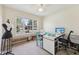 Office space featuring large windows, a sewing machine, and ample desk space at 7450 Deville Ct, Indianapolis, IN 46256