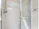 Close-up of the shower, showcasing chrome hardware and a sliding glass door at 7450 Deville Ct, Indianapolis, IN 46256