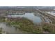 An aerial view showcasing the lake, waterfront properties, and surrounding lush greenery at 7640 Bay Shore Dr, Indianapolis, IN 46240