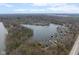 Aerial view of lakefront community with mature trees, docks, and water access at 7640 Bay Shore Dr, Indianapolis, IN 46240