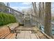 Landscaped backyard with gray staircase, patio, bench and view of mature trees at 7640 Bay Shore Dr, Indianapolis, IN 46240