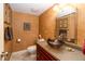 Cozy powder room featuring unique bowl sink, decorative art, and neutral-toned textured walls at 7640 Bay Shore Dr, Indianapolis, IN 46240