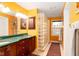 Bright bathroom with double sinks, glass block shower, and tiled floor at 7640 Bay Shore Dr, Indianapolis, IN 46240