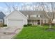 Charming two-story home featuring a well-maintained lawn, inviting porch, and an attached two car garage at 7640 Bay Shore Dr, Indianapolis, IN 46240