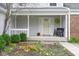 Inviting front porch with a seating bench, decorative wreath, and well-maintained landscaping at 7640 Bay Shore Dr, Indianapolis, IN 46240