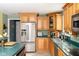 Kitchen featuring wood cabinets, stainless steel refrigerator, and sleek counter tops at 7640 Bay Shore Dr, Indianapolis, IN 46240