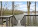 Steps leading to a private dock offering breathtaking views of a serene lake at 7640 Bay Shore Dr, Indianapolis, IN 46240