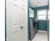 Well-equipped laundry room with modern washer and dryer, storage cabinets, and natural light at 7640 Bay Shore Dr, Indianapolis, IN 46240