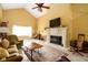 Bright living room with a vaulted ceiling, brick fireplace, neutral colors, and ample natural light at 7640 Bay Shore Dr, Indianapolis, IN 46240