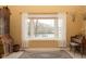 Cozy living room featuring a bay window with backyard view and decorative sheer curtains at 7640 Bay Shore Dr, Indianapolis, IN 46240