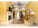 Open-concept living room showcasing the vaulted ceilings, fireplace, and access to upper level at 7640 Bay Shore Dr, Indianapolis, IN 46240