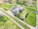 An aerial view of the home showcases its expansive lot, mature trees, and unique architectural design at 7748 S State Road 39, Clayton, IN 46118