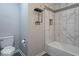 Bathroom featuring a tiled tub and shower with matte black accessories and a toilet at 7748 S State Road 39, Clayton, IN 46118