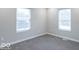 Bedroom featuring plush carpet, two windows, and neutral paint at 7748 S State Road 39, Clayton, IN 46118