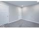 Bedroom features neutral walls and plush carpet, with two entry doors at 7748 S State Road 39, Clayton, IN 46118