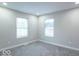 Neutral bedroom with two windows, plush carpet, and fresh neutral paint at 7748 S State Road 39, Clayton, IN 46118