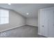Cozy bedroom features neutral walls and carpet plus a bright window and white door at 7748 S State Road 39, Clayton, IN 46118