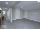 Spacious hallway with grey carpet leads to rooms with neutral walls, white trim and doors at 7748 S State Road 39, Clayton, IN 46118