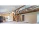Open floorplan featuring a vaulted ceiling, wooden beam staircase and balcony, and bright kitchen at 7748 S State Road 39, Clayton, IN 46118
