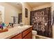Bathroom featuring wood-colored cabinets, granite counters, and a cute shower curtain at 7782 Rose Ln, Ingalls, IN 46048