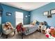 Cozy blue bedroom with a single bed, plush toys and a chevron chair at 7782 Rose Ln, Ingalls, IN 46048