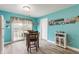 Bright dining area with blue walls, light wood floors, and sliding glass doors to the backyard patio at 7782 Rose Ln, Ingalls, IN 46048