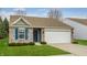 Lovely single-story home featuring a brick facade, attached two-car garage, and a well-manicured front lawn at 7782 Rose Ln, Ingalls, IN 46048