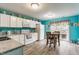 Bright kitchen with white cabinetry, a breakfast nook, and modern appliances for a functional cooking space at 7782 Rose Ln, Ingalls, IN 46048