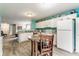 Inviting kitchen with white cabinetry, a cozy dining area, and an open layout ideal for entertaining at 7782 Rose Ln, Ingalls, IN 46048
