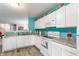 Bright kitchen with white cabinets and appliances including an oven, microwave, and dishwasher at 7782 Rose Ln, Ingalls, IN 46048