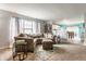 Spacious living room featuring neutral tones, plush seating, and an open layout leading to the kitchen at 7782 Rose Ln, Ingalls, IN 46048