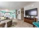 Open-concept living room with a comfortable layout, carpeted floors, and a seamless flow to the dining area at 7782 Rose Ln, Ingalls, IN 46048