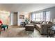Comfortable living room featuring plush seating, carpeted floors, and a large window providing natural light at 7782 Rose Ln, Ingalls, IN 46048