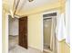 Simple bathroom area with a wooden door leading to another room and a shower at 80 S Richland Ave, Carmel, IN 46032