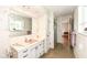 Bathroom with floral wallpaper, pink countertop and white tiled walls at 80 S Richland Ave, Carmel, IN 46032