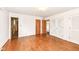 Bright bedroom featuring hardwood floors, white walls, and ample closet space at 80 S Richland Ave, Carmel, IN 46032