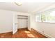 Bedroom with hardwood floors, closet, and window providing ample natural light at 80 S Richland Ave, Carmel, IN 46032