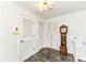 Hallway with light walls, tiled floor, wood doors, and vintage grandfather clock at 80 S Richland Ave, Carmel, IN 46032